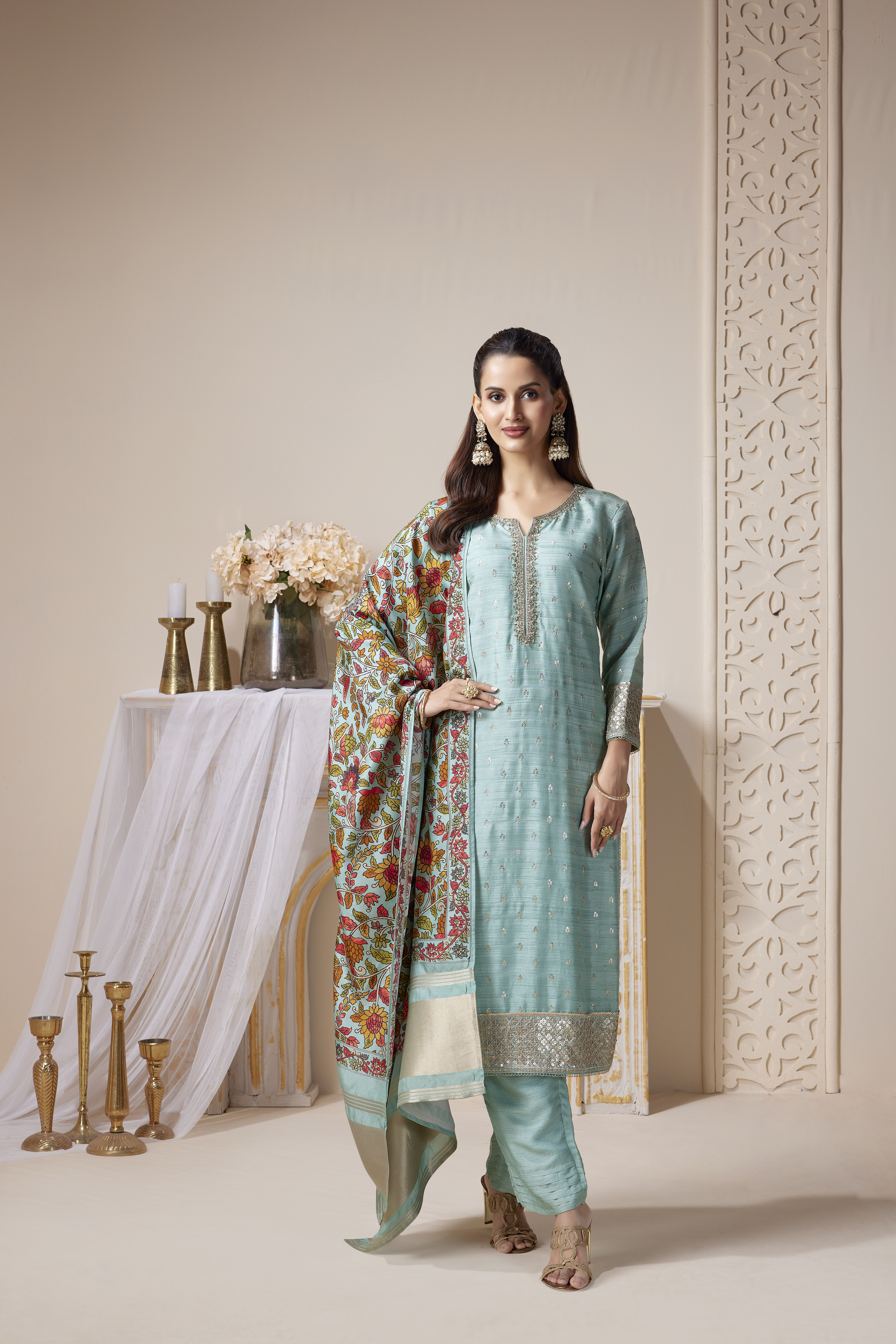 Woman wearing aqua embroidered kurta set with floral dupatta and straight pants, ethnic festive outfit