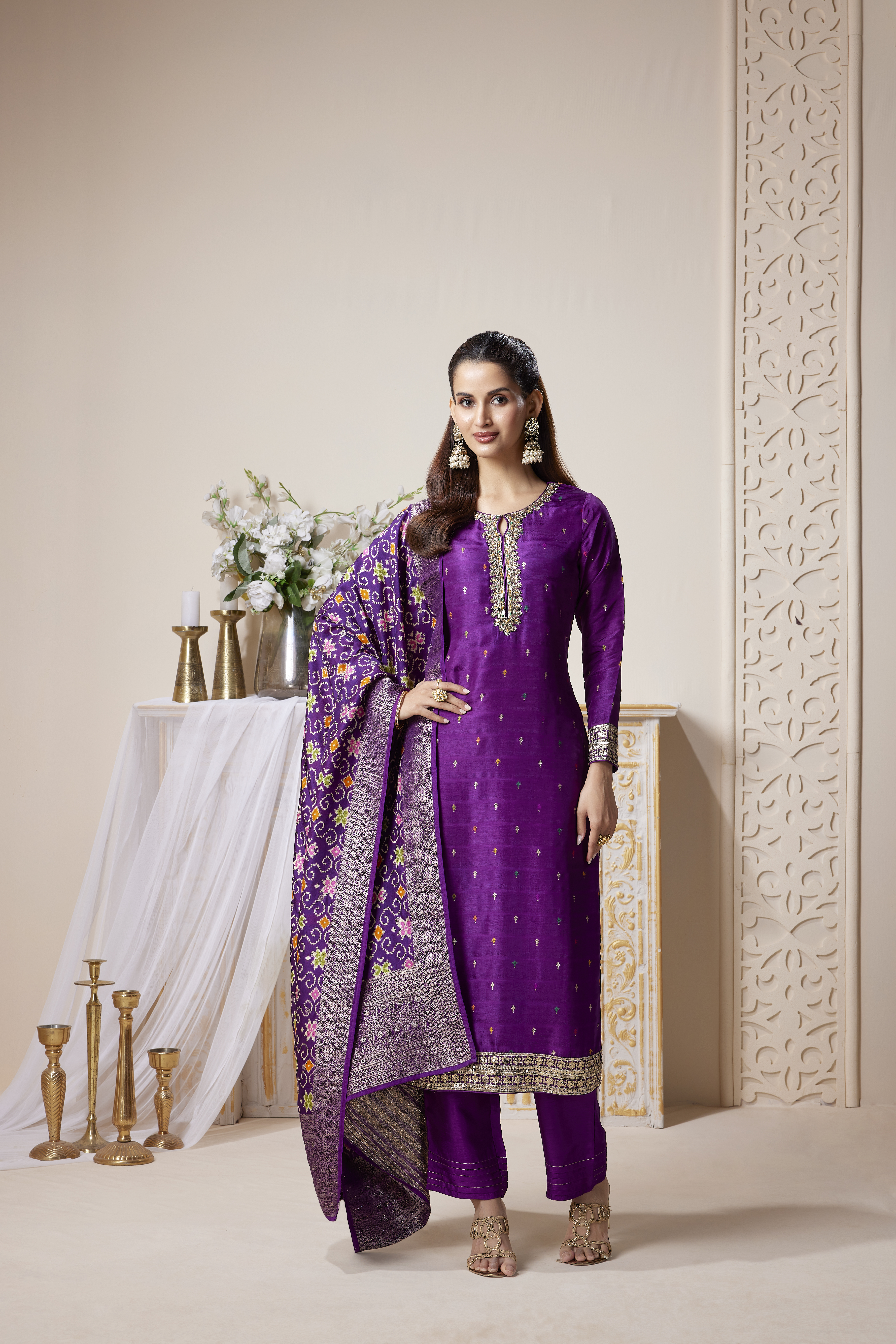 Woman wearing royal violet embroidered kurta set with woven dupatta and straight pants, festive ethnic outfit