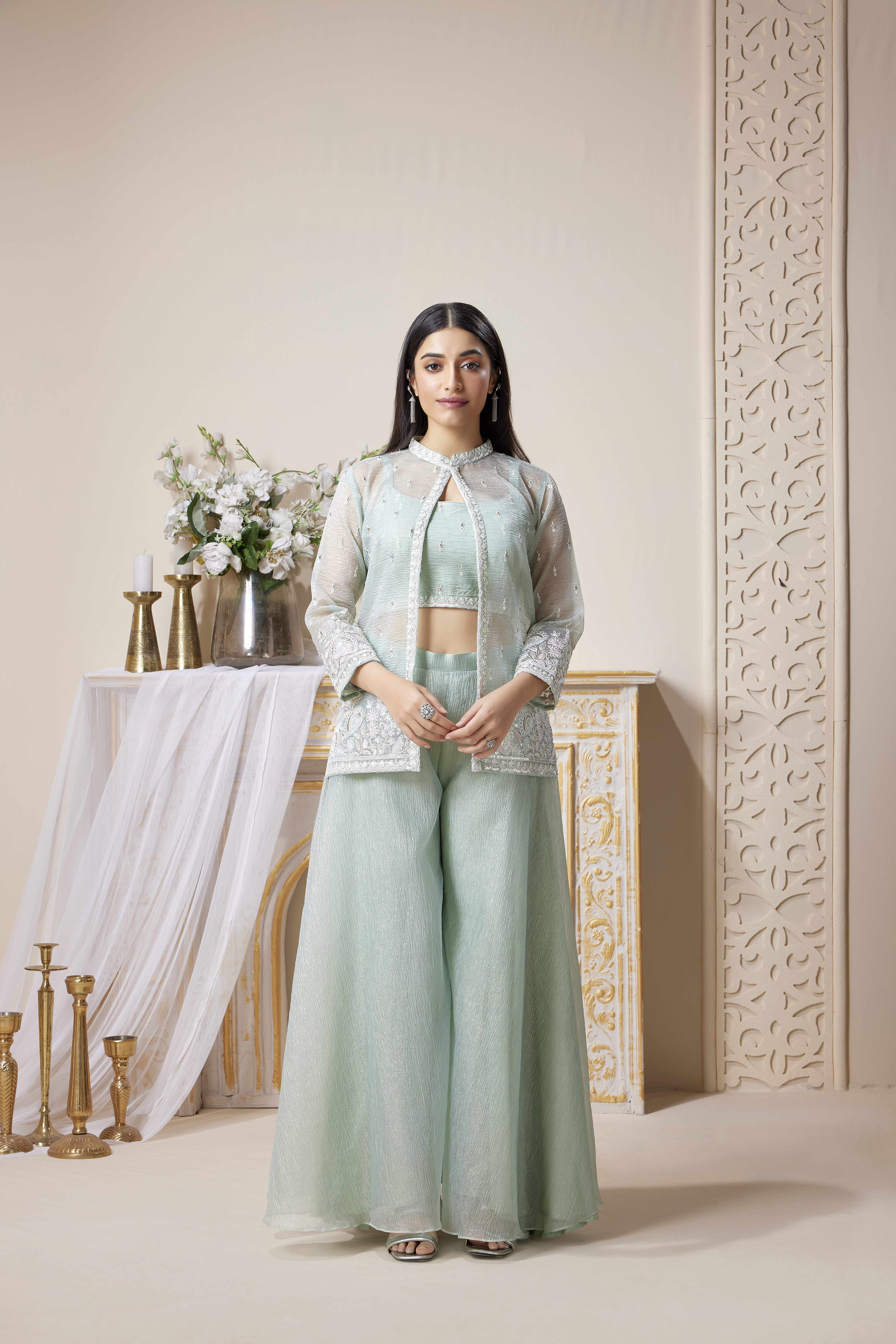 Woman wearing mint green co-ord set with embroidered sheer jacket, crop top and wide-leg pants, modern ethnic outfit