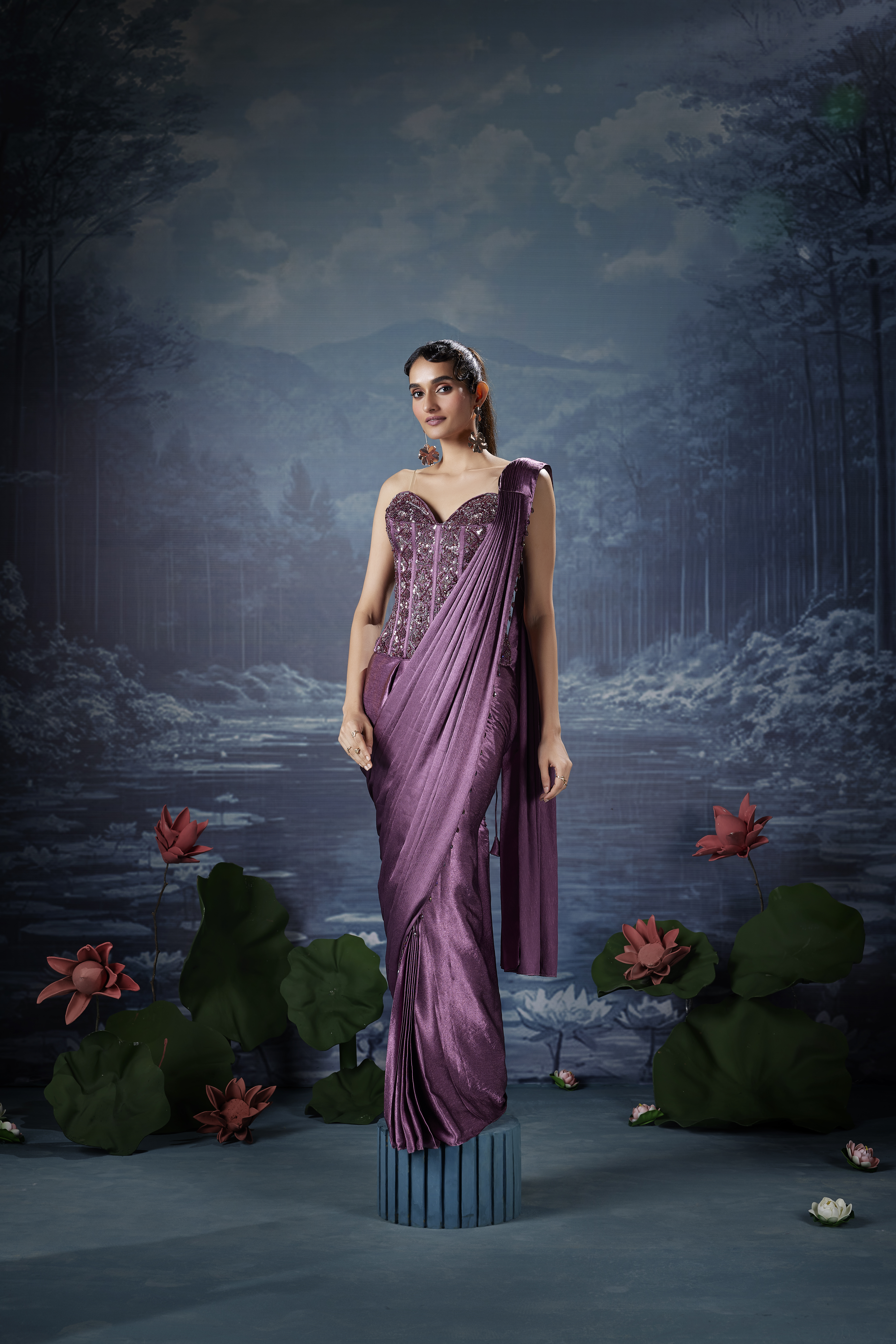 Woman wearing plum mauve designer saree with corset style embellished blouse, elegant modern saree look with structured blouse and evening styling